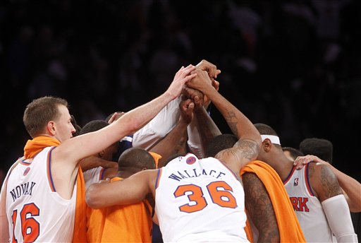 The New York Knicks celebrate at mid-court after defeating the Miami Heat. Photo Courtesy Yahoo Sports (AP Photo/Jason DeCrow)